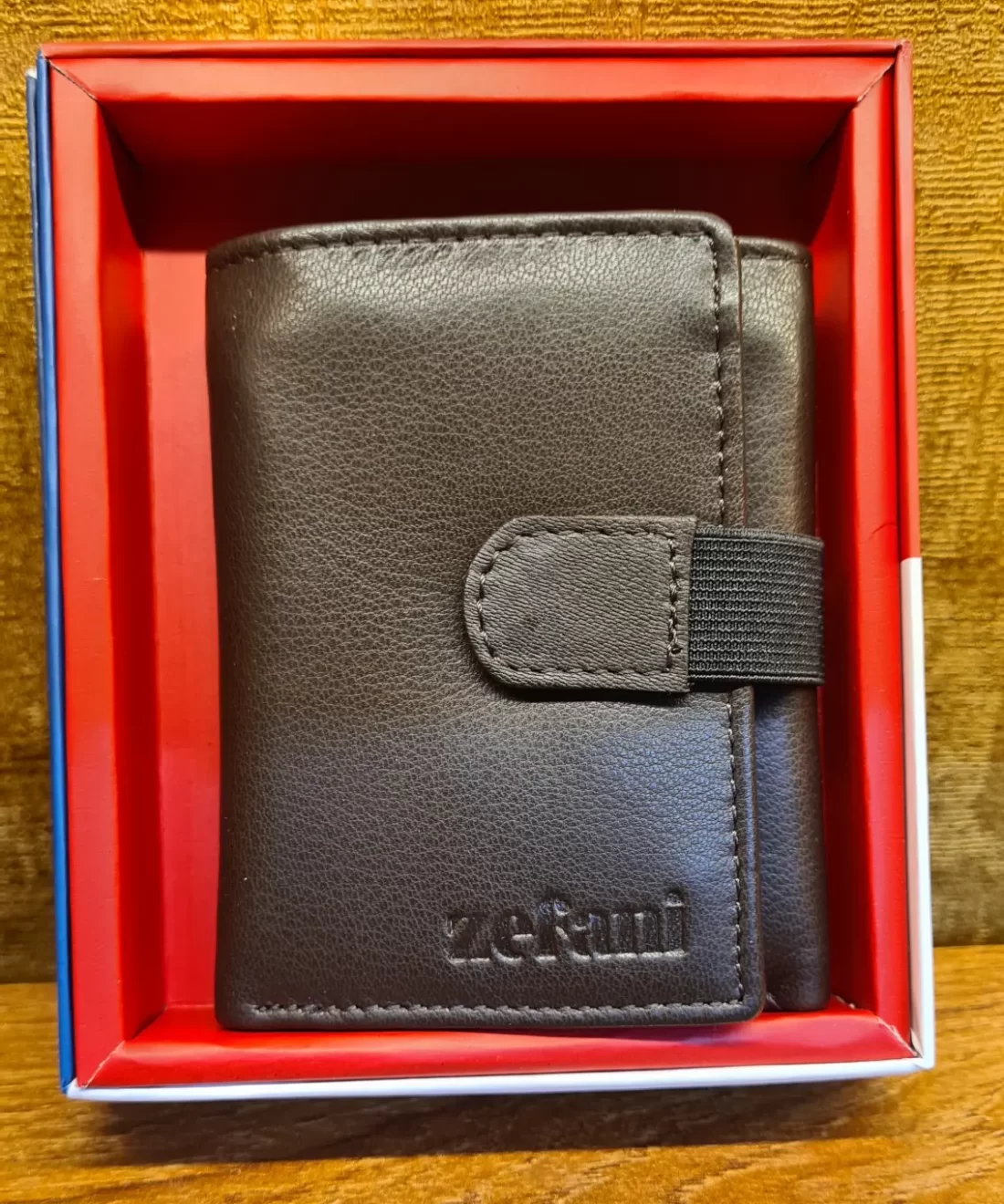 Black strap-fastening leather wallet
